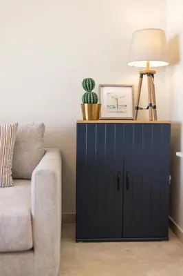 a blue cabinet with a lamp on it next to a couch at Luxury 2BR Apartment City Center with Parking in Casablanca