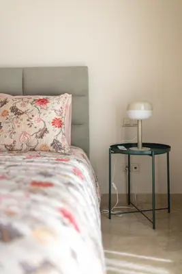 a bedroom with a bed and a nightstand with a lamp at Luxury 2BR Apartment City Center with Parking in Casablanca