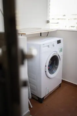 a washing machine in a room with a window at Luxury 2BR Apartment City Center with Parking in Casablanca