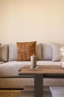 a couch with pillows and a table in a living room at Luxury 2BR Apartment City Center with Parking in Casablanca