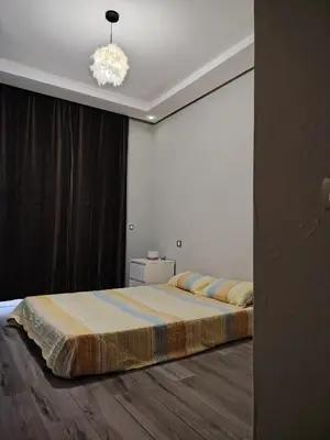a bedroom with a bed and a chandelier at Le mataki in Mohammedia