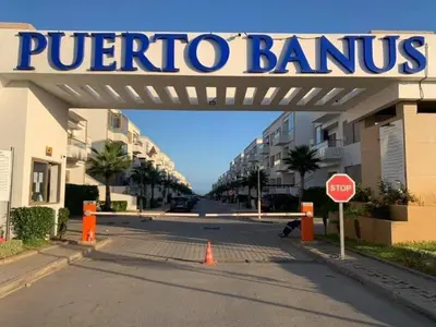a sign over a street with a stop sign at Puerto banus appartement in Mohammedia