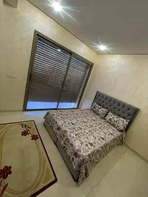 a bedroom with a bed in a room with a window at Puerto banus appartement in Mohammedia