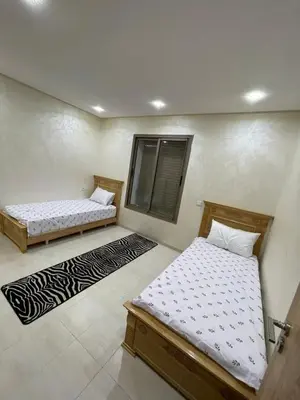a bedroom with two beds and a window at Puerto banus appartement in Mohammedia