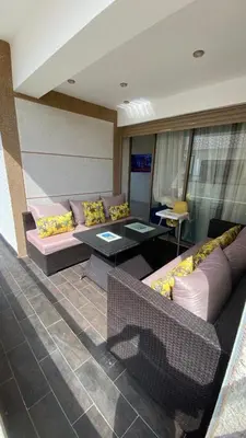 a living room with couches and a table at Puerto banus appartement in Mohammedia