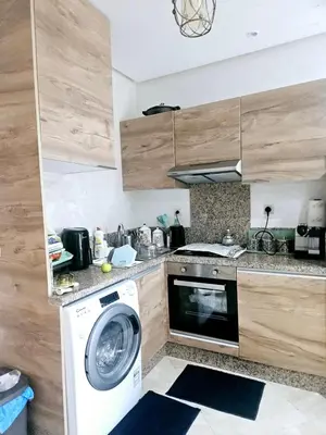 a kitchen with a washer and a washing machine at Buznika marocco in Bouznika