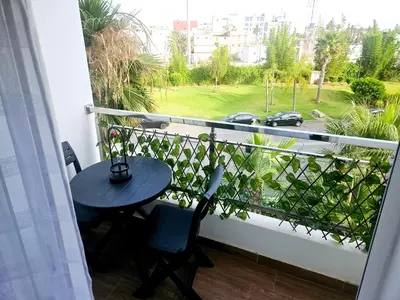 a balcony with a table and a view of a street at Buznika marocco in Bouznika