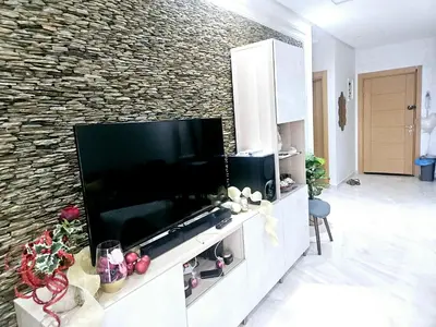 a living room with a large flat screen tv at Buznika marocco in Bouznika