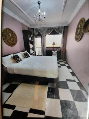 a bedroom with a bed and a checkered floor at Spacious with Great Location in Casablanca