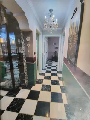 a hallway with a checkered floor and a chandelier at Spacious with Great Location in Casablanca