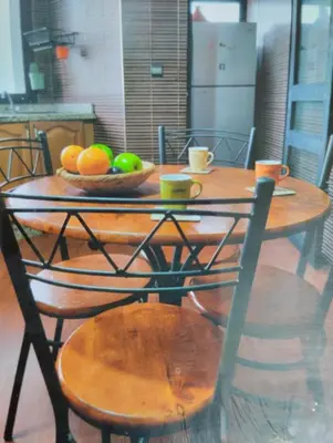 a wooden table with a bowl of fruit on it at Spacious with Great Location in Casablanca