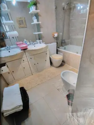 a bathroom with two sinks and a toilet and a shower at Spacious with Great Location in Casablanca