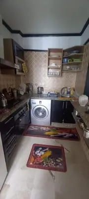 a kitchen with a sink and a washing machine at Vue Mer & Sérénité, Appartement Chic avec Piscine à Dar Bouazza in Tamaris