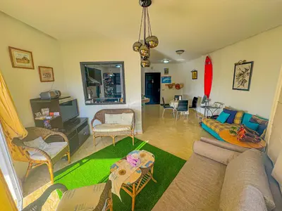 a living room with a couch and a table at DarBouazza SurfHouse Sea View in Tamaris