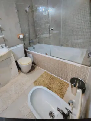 a bathroom with a tub and a toilet and a sink at Rosy Bliss in Casablanca
