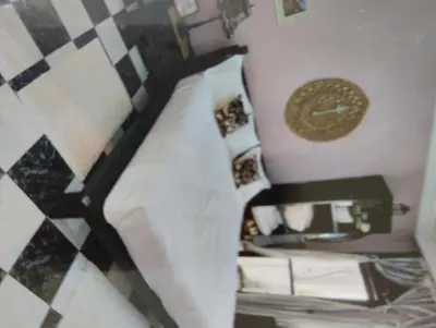 a room with a bed and a clock on a wall at Rosy Bliss in Casablanca