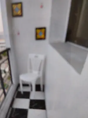 a room with a table and a chair and a checkered floor at Rosy Bliss in Casablanca
