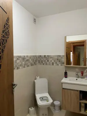 a bathroom with a toilet and a sink at ossama in Mansouria
