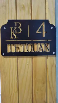 a sign that reads k hospital on a wooden wall at Studio Tetouan in Deroua