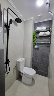a bathroom with a white toilet and a shower at Studio Tetouan in Deroua