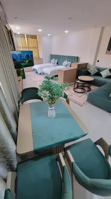 a living room with a table and chairs and a couch at Studio Tetouan in Deroua