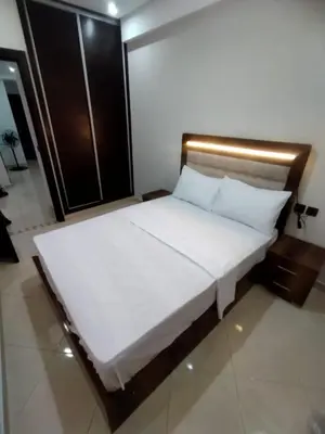 a bedroom with a large bed with white sheets at Relaxation stay in Casablanca