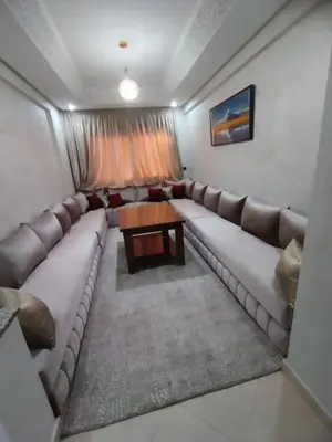 a living room with a large couch and a table at Relaxation stay in Casablanca