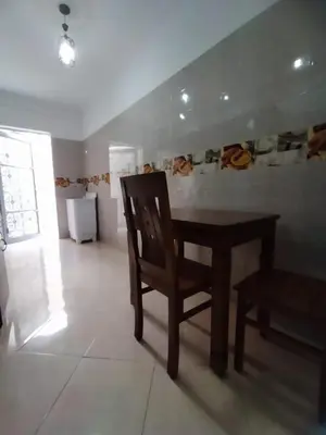 a dining room with a wooden table and a chair at Relaxation stay in Casablanca