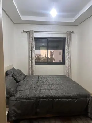 a bed in a bedroom with a window at Ocean Park Apartment for rent in Casablanca