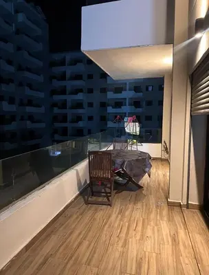 a dining room with a table and a large window at Ocean Park Apartment for rent in Casablanca