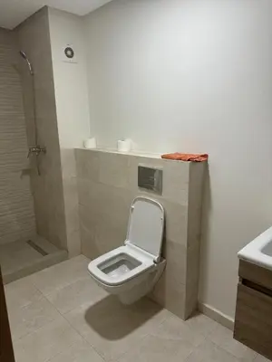 a bathroom with a toilet and a shower at Ocean Park Apartment for rent in Casablanca