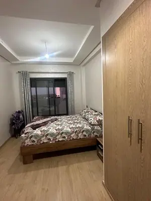 a bedroom with a bed and a large closet at Ocean Park Apartment for rent in Casablanca