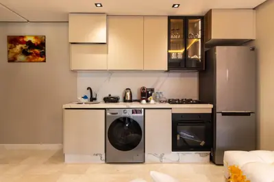 a kitchen with a washer and a refrigerator at Small nest in a good location, quiet in Casablanca