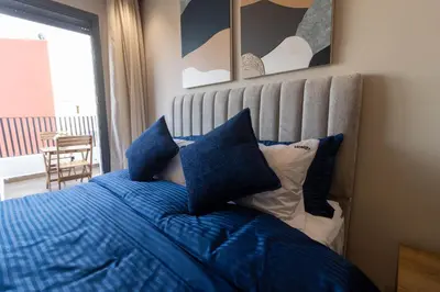 a bed with blue sheets and pillows in a bedroom at Small nest in a good location, quiet in Casablanca