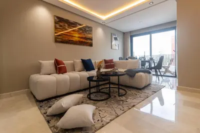 a living room with a couch and a table at Small nest in a good location, quiet in Casablanca