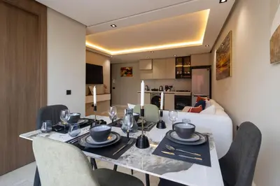 a dining room with a table and a couch at Small nest in a good location, quiet in Casablanca