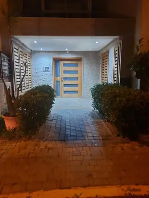 a front door of a house at night at Séjour Idéal à Tamaris Appartement Meublé Tout Confort in Tamaris