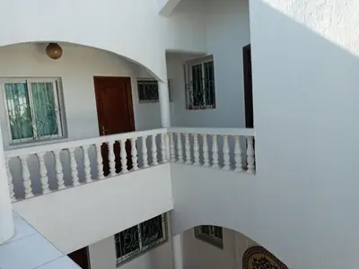 a staircase in a house with white walls at Riad JOUHARA in Skhirat