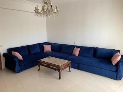 a blue couch in a living room with a coffee table at Martil in Anfa-Supérieur