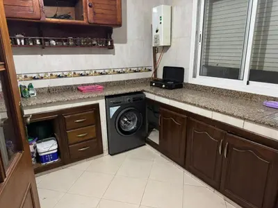 a kitchen with a washing machine in a kitchen at Martil in Anfa-Supérieur
