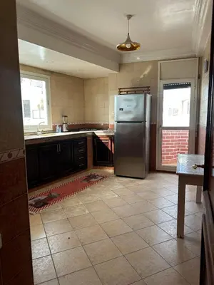 a kitchen with a refrigerator and a tile floor at Apartment in Casablanca Maarif in Casablanca