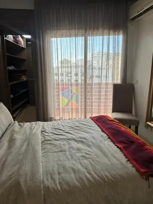 a bedroom with a bed and a chair and a window at Apartment in Casablanca Maarif in Casablanca