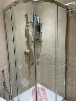 a shower with a glass door in a bathroom at lumineux appartement in Bouznika