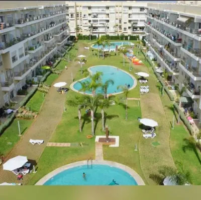 an aerial view of two swimming pools in a resort at lumineux appartement in Bouznika