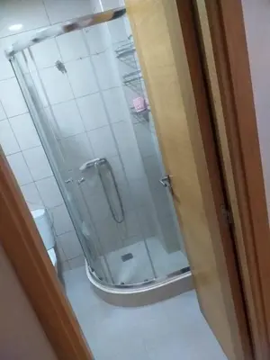 a shower with a glass door in a bathroom at Blanca beach in Casablanca