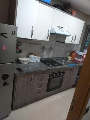 a kitchen with white cabinets and a stove top oven at Blanca beach in Casablanca