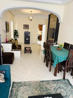 a living room with a blue table and chairs at Havre de paix au centre de Casablanca in Casablanca