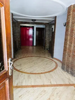 an empty room with a wooden floor and a red door at Havre de paix au centre de Casablanca in Casablanca