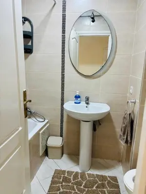 a bathroom with a sink and a mirror at Havre de paix au centre de Casablanca in Casablanca