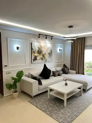 a living room with a couch and a table at M4 Spacious Appartment in Exclusive Residence by the Sea in Rabat